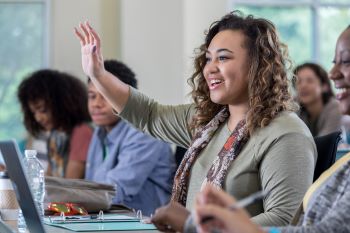 student raising hand in class