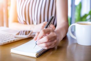 woman writing in notebook